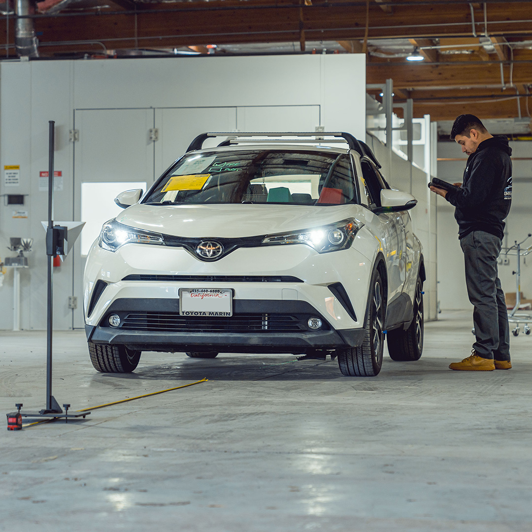 Omni Automotive Technologies Tech working inside of a Sonoma County Auto Body shop.