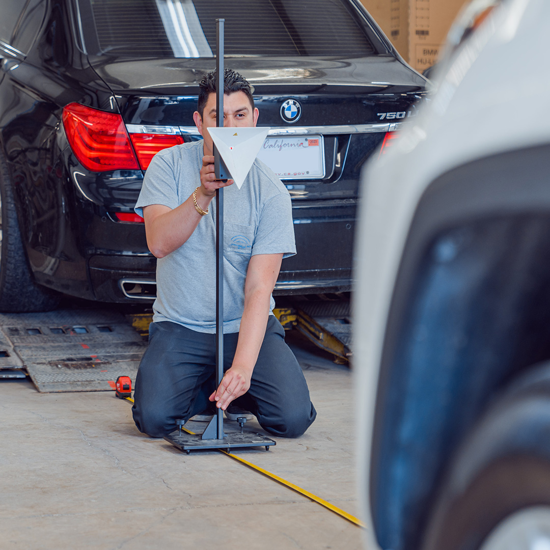 Omni Automotive Technologies team providing services inside of an auto body shop.